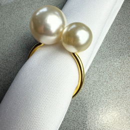 Elegant pearl gold napkin ring with two large white pearls on a gold band.