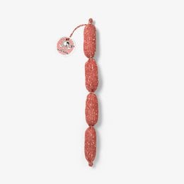 A red sausage-shaped statue with a round ornament attached.