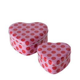  A set of two heart-shaped storage jars in a pink and red polka dot pattern. The jars are made of a durable material and have a lid for keeping contents fresh.