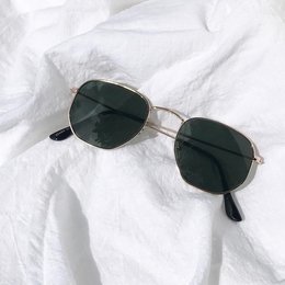 Black metal-framed sunglasses with dark lenses in a hexagonal shape.