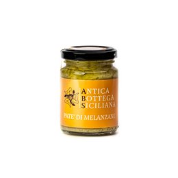 Aubergine pate in a glass jar with a black lid. The label on the jar indicates it is a product of Antica Bottega Siciliana, a brand specializing in Sicilian delicacies. The pate appears to be a spreadable eggplant-based product.