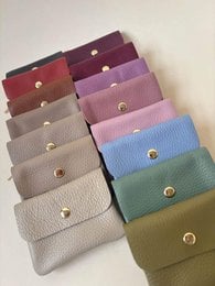 Leather wallet in multiple colors including beige, green, orange, red, and blue. Compact size with snap closure.