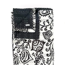 Large black and white patterned throw blanket with a mix of paisley and abstract designs.