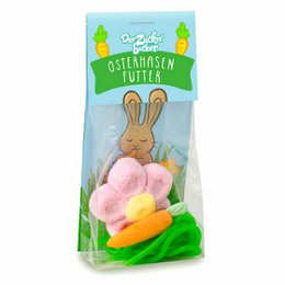Colorful Easter candy bag with a plush bunny toy. Contains a variety of pastel-colored candies in different shapes and sizes, including jelly beans, marshmallows, and chocolate-coated candies. Ideal for Easter baskets and holiday celebrations.