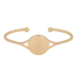 A gold-toned cuff bracelet with a circular signet-style design in the center.