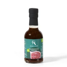 Organic balsamic cream with figs in a glass bottle. The product is made of balsamic vinegar and figs, with a dark brown color and a sweet, tangy flavor.