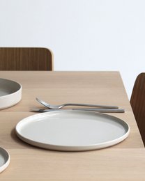  Large round dinner plate, sand beige color, ceramic material, minimalist modern style, flat shape with rim.