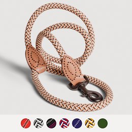  A durable, stylish dog leash made of braided material in a variety of color combinations, including brown-white-yellow, blue-reflective, red-black-white, blue-white-red, olive green, black-purple-white, and black-and-white-gray.
