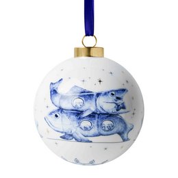  White ceramic round Christmas ornament with blue fish design, navy ribbon, gold cap, decorative holiday bauble.