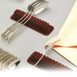 Cutlery organizer made of red plastic with grooves to hold and separate utensils. Designed for efficient storage and organization of kitchen tools.