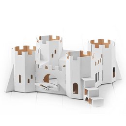 A large, white cardboard castle with towers, battlements, and a skull design. The castle appears to be a toy or craft item, suitable for children's play or decoration.