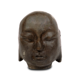 Small, serene stone statue of a monk with closed eyes and peaceful expression.