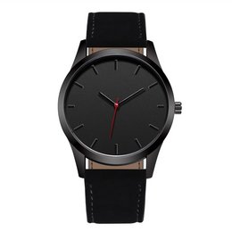 A black watch with a simple, minimalist design. The watch features a black dial with red hands and a black leather strap.