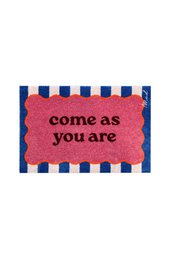 Pink coir doormat with navy blue striped border, "come as you are" text, rectangular shape, motivational welcome mat.
