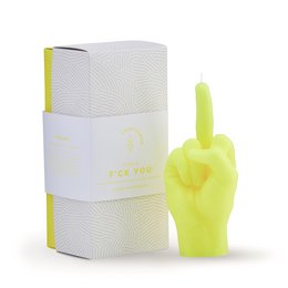Neon yellow candle in the shape of a hand giving the middle finger gesture. The candle is packaged in a white box with a wavy pattern.