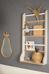 White wooden wall shelf with various decorative items, including a woven basket, a wooden figurine, and some books.