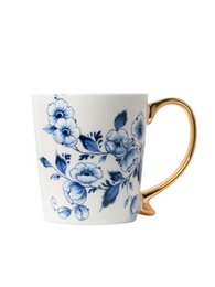  A white ceramic mug with a blue floral pattern and a gold-colored handle.