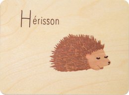 Wooden card with a hedgehog illustration and the title "Herisson". The card appears to be part of a children's educational product featuring animal illustrations.