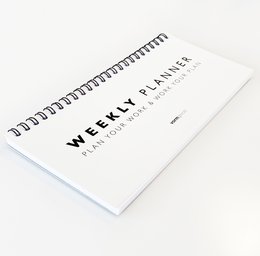 Weekly planner with spiral binding and blank pages for organizing your schedule.