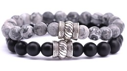 A set of beaded bracelets featuring a mix of gray and black stones, with a textured metal accent bead.