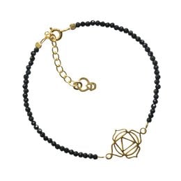 A gold-toned charm bracelet with black beads and a gold-toned lotus flower charm. The bracelet features an adjustable clasp for a customized fit.