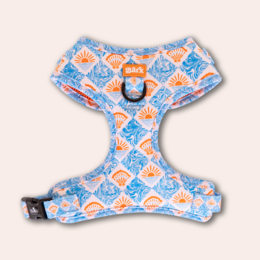 Adjustable dog harness with a vibrant, patterned design featuring orange and blue shapes. Suitable for XXS, XS, S, M, and L dog sizes.