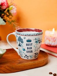 White ceramic mug with "Best Dad Ever" text, blue floral pattern, decorative rim, father's day gift