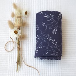 Soft, lightweight swaddle blanket with delicate floral pattern in navy blue and white. Made of breathable, natural cotton fabric. Ideal for swaddling newborns and infants.