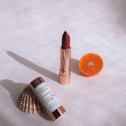 Natural lipstick in deep red color with a creamy, moisturizing formula.