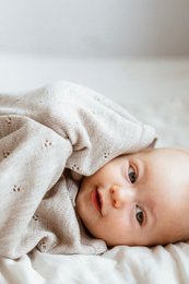  Soft, cozy 100% merino wool baby blanket in neutral beige color, made in Poland, measures 75x100cm.