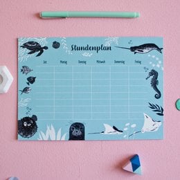 The image shows a desk calendar with an underwater animal theme. The calendar has a light blue background with various marine creatures such as whales, dolphins, and sea turtles depicted around the edges. The title of the calendar is "Timetable underwater animals A5".