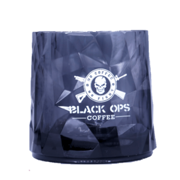 A tall, cylindrical tumbler glass with a black and white logo design featuring a skull and crossbones. The glass appears to be made of a durable, shatterproof material.