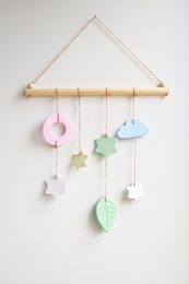 Colorful hanging wall decor with leaf and star shapes for a nursery.