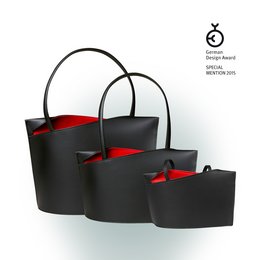 A set of black shoulder bags with red accents. The bags come in three sizes: small, medium, and large. The bags have a simple, minimalist design with a curved handle.