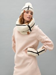 Warm, cozy cream-colored knit hat with black trim and a pom-pom on top. Made of wool material, suitable for cold weather.