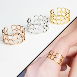 Adjustable open stainless steel ring in gold, rose gold, and silver tones. Features a honeycomb-inspired design that is hypoallergenic and waterproof.