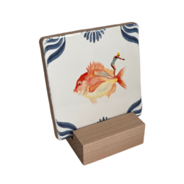 Decorative wooden tile holder with an image of a colorful goldfish against a patterned background.
