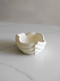  Elegant white ceramic vase with a unique abstract shape, suitable for displaying flowers or decorative items.