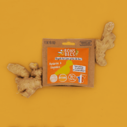 Mandarin & Ginger bonbons in a bright orange package. The bonbons are round and appear to be made of a soft, chewy material. The package prominently displays the "Bons Becs" brand name and indicates the bonbons are made with natural ingredients.