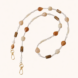  A long phone chain made of beige and brown natural stone beads, with a clasp at each end to attach to a phone or other device.