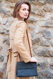 Black leather handbag with a structured silhouette and a detachable shoulder strap. Crafted from high-quality materials for a durable and stylish design.
