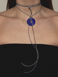  Posie Round Necklace in baby blue with cord options in various colors. Pendant features a round blue glass bead.