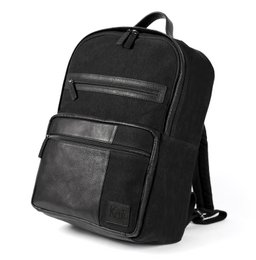  Black canvas and genuine leather backpack with zip closure, antiqued nickel accessories, and dimensions of 29 x 40 x 15 cm.