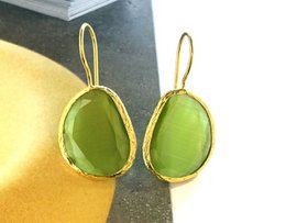 Olive green cat-eye stone drop earrings with a gold-tone metal frame.