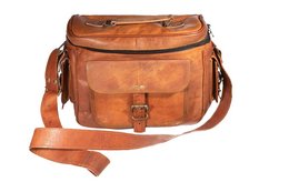 Rugged leather camera bag in a warm brown color, featuring multiple pockets and a detachable shoulder strap for versatile carrying.