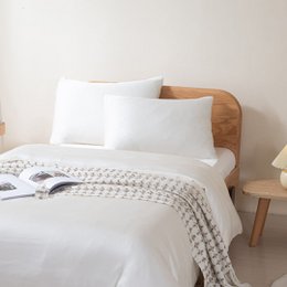  Soft, luxurious cream-colored pillowcases made of premium materials for a comfortable sleep experience.