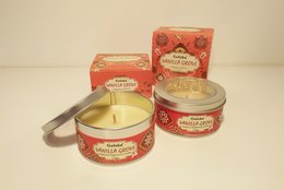 Scented candle with a vanilla fragrance, packaged in a round container with a red and gold label.