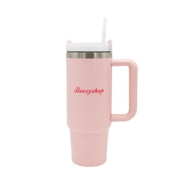  A pink insulated travel mug with the text "Boozyshop" printed on it.