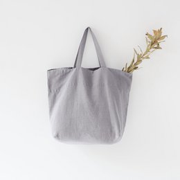 Large light grey linen tote bag with long handles for shopping or everyday use.