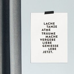 A poster with the text "Lache, manze, atme, traume, mache, vergebe, liebe, geniesse, lebe jetzt." The poster has a minimalist, typographic design with black text on a white background.